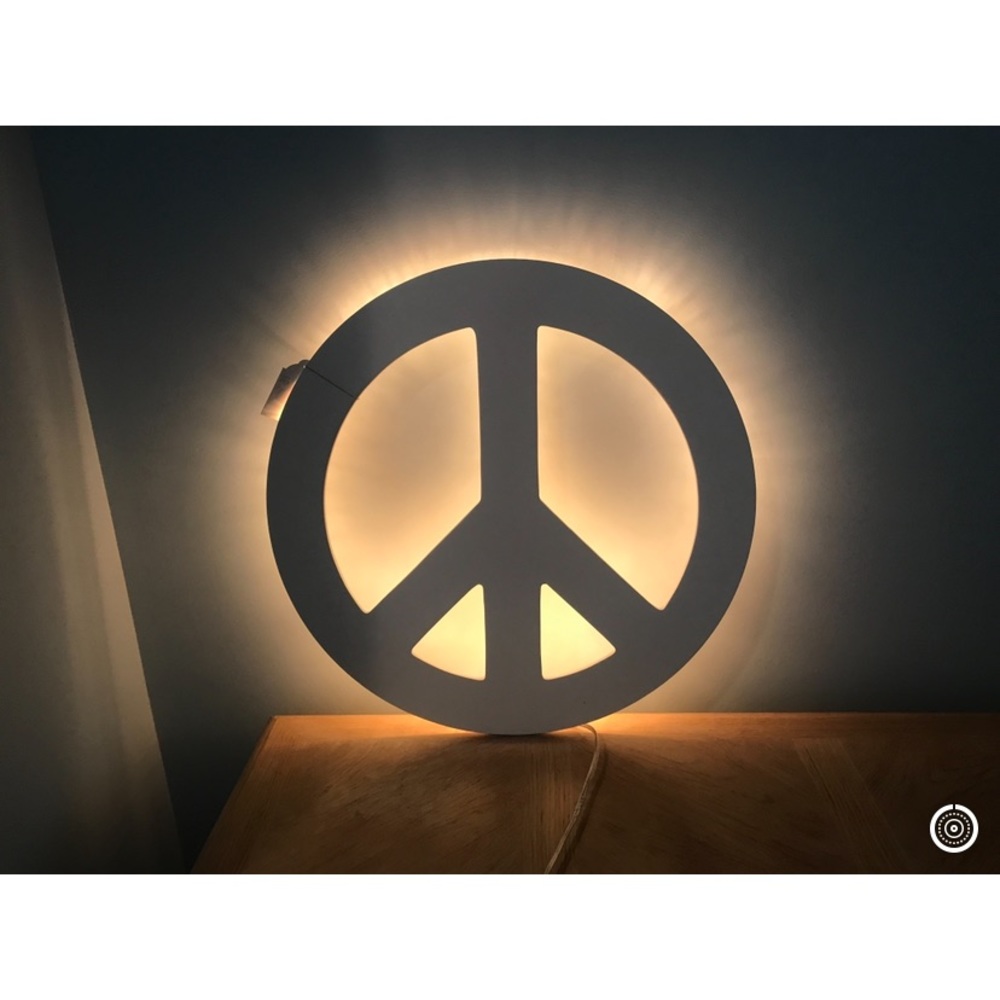PB Teen white backlit peace sign light.